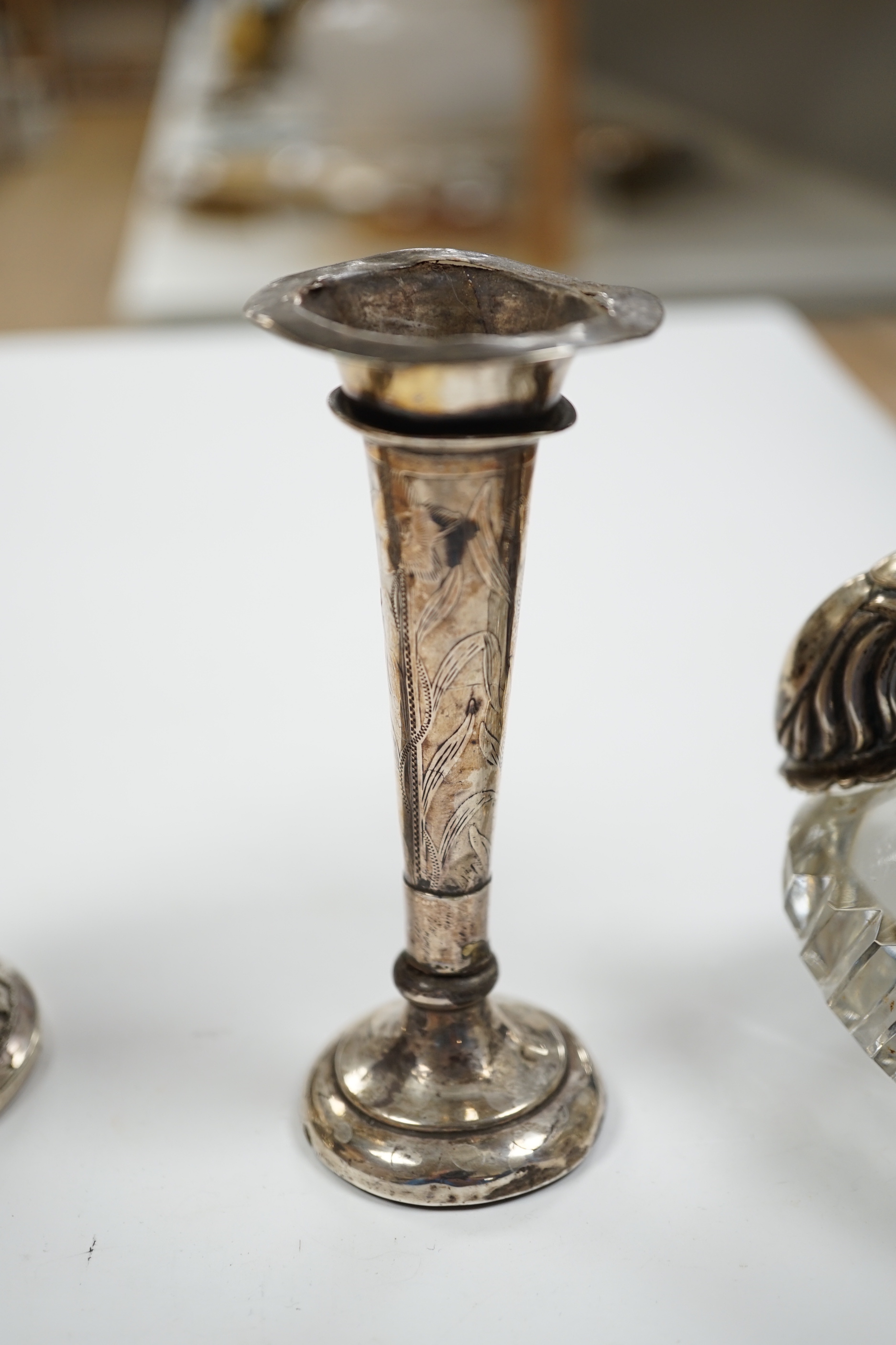 Two small white metal candlesticks, 8cm, an Indian vase, silver posy vase and a white metal mounted glass swan dish, a.f.